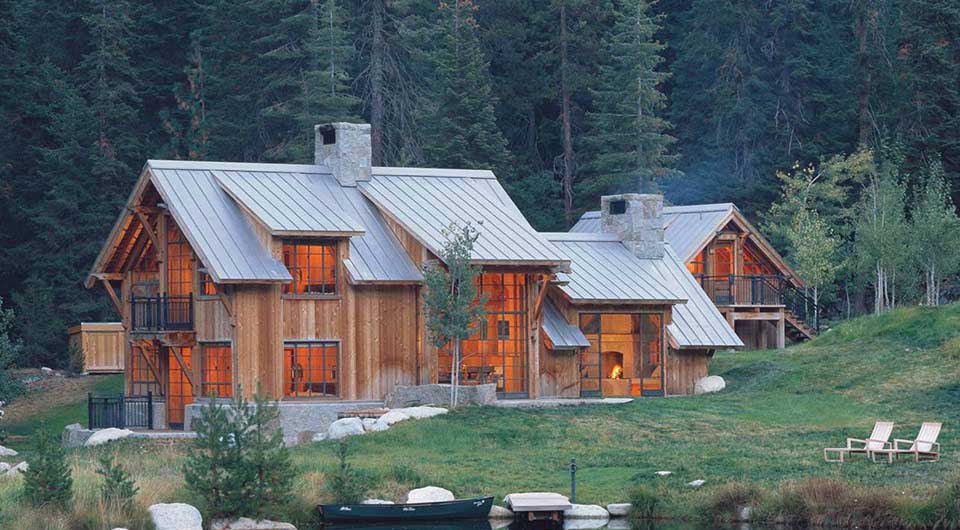 Metal roof shown on a log cabin in a forest